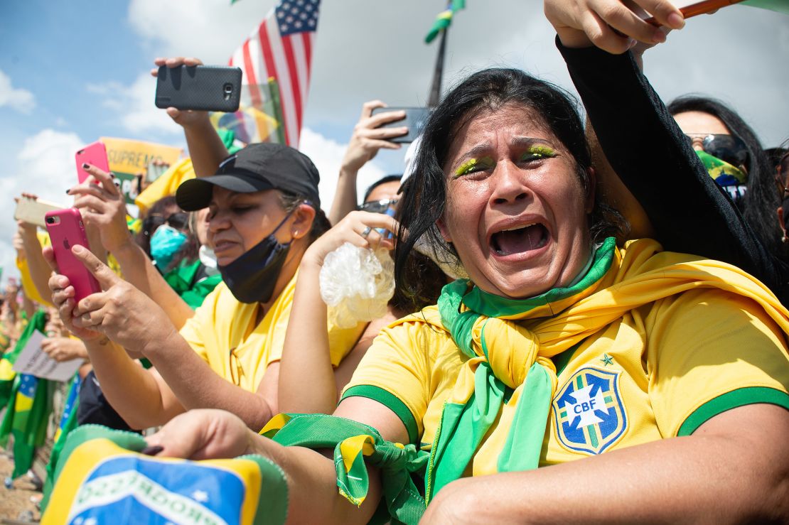A supporter of Brazilian President Jair Bolsonaro cries during a demonstration in favor of his government amidst the coronavirus pandemic in front of Planalto Palace on May 24, 2020 in Brasilia, Brazil.