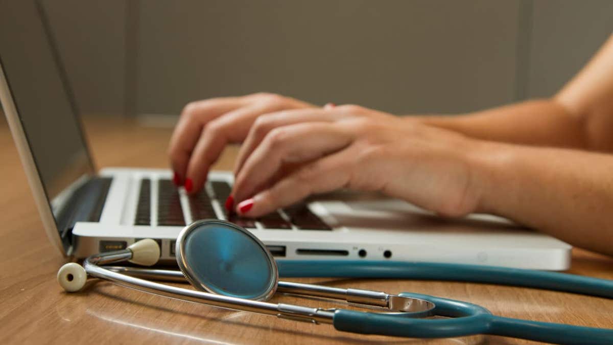 health care worker on laptop