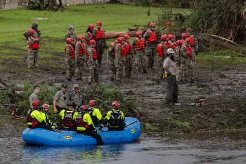 Getty Images Search and recovery workers dig through debris looking for any survivors or remains of people swept up in the flash flooding at Camp Mystic on July 6, 2025 in Hunt, Texas. Heavy rainfall caused flooding along the Guadalupe River in central Texas with multiple fatalities reported. 