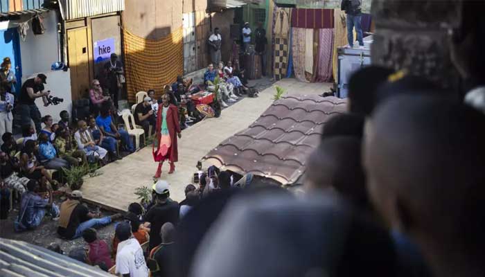Models show off outfits created by local fashion designers specialising in upcycling discarded fabrics and garments from second-hand clothes markets. — AFP