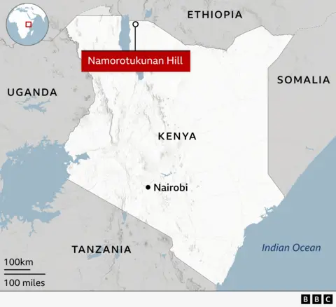 Map of Kenya in East Africa, surrounded by Uganda to the west, Tanzania to the south, Ethiopia to the north, and Somalia to the east, with the Indian Ocean on its southeast coast. The map highlights a specific location named Namorotukunan Hill in northwestern Kenya, almost on the border with Ethiopia. Nairobi, the capital city of Kenya, is marked further south in the middle of the country. A small inset globe at the top left corner displays Kenya's position within Africa.